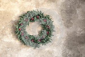 Christmas wreath on gray marble wall