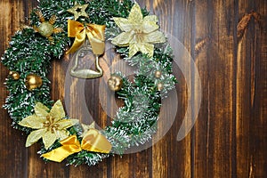 Christmas wreath hanging on wooden door front view. Decoration concept
