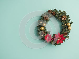 Christmas wreath on light blue background