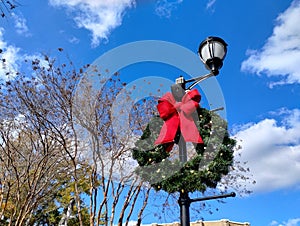 Christmas wreath on light pole blue sky