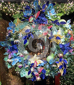 Christmas wreath with multi color artificial flowers, feather and balls
