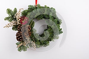 Christmas Wreath, With Pine Cones and Red Flower Ornament, Handmade. Isolated on White Background,