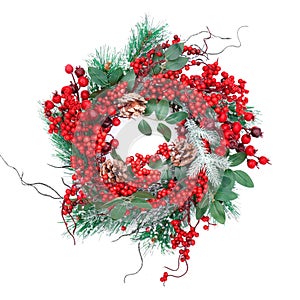 Christmas wreath with red berries isolated on a white background. Traditional New Year`s wreath close-up top view