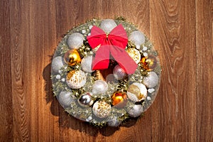 Christmas wreath with a red bow and Christmas toys balls.