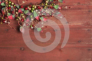 Christmas wreath on red grunge wood background