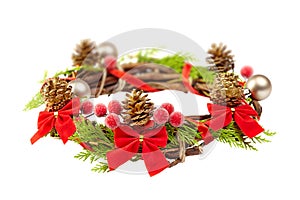 christmas wreath with red ribbon,pine cones and golden decoration isolated on white background