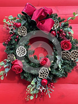 Christmas wreath on a red wall outdoor