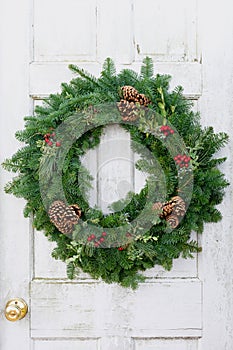 Christmas wreath on rustic white door