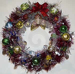 Christmas wreath of tinsel, fir cones, New Year decorations. Isolated, white background
