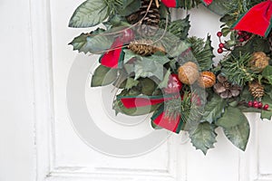 Christmas Wreath on White Door with Red Ribbon