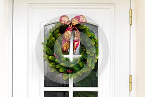 Christmas wreath on a white home doors