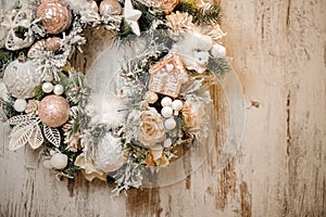 Christmas wreath with white and rosa color toys, balls, tapes and flowers photo