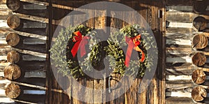 Christmas wreaths on the doors of an old log church in the Appalachian Mountains in Virginia