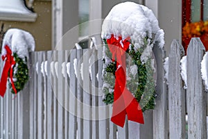 Christmas wreaths on picket fence in Daybreak Utah