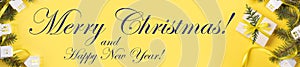 Christmas yellow banner with DIY gift box, green fir branches, Xmas lights white lodges, inscription Merry Christmas