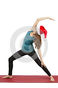 Christmas yoga woman doing reversed warrior pose