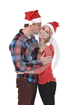 Christmas young beautiful couple in Santa hats in love smiling happy together hugging each other sweet
