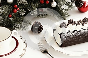 Christmas Yule Log Cake with Festive Decor and Evergreen Branches
