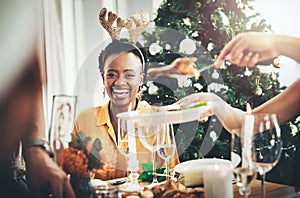 Christmases lunches are my favourite thing ever. an attractive young woman smiling while having Christmas lunch with her