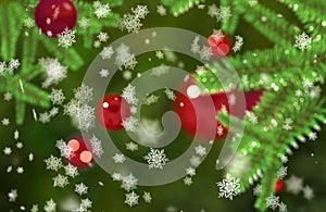 Christmass mood snowflakes falling on a green fir tree branches Bokeh background