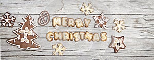Christmassy grey wood background with gingerbread and Merry Christma`s letter
