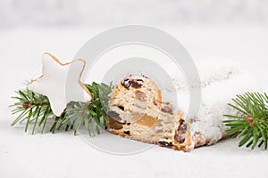 Christstollen, traditonal christmas cake with nuts, raisons, marzipan on a blue background