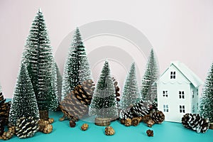 Christmas and happy new year holidays background with Christmas trees and pine cone on pink and blue background