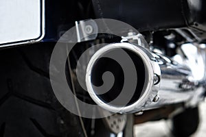 Chrome biker motorcycle exhaust pipe. Problems of ecology and air pollution