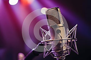 Chrome condenser microphone close up on stage, professional audio equipment