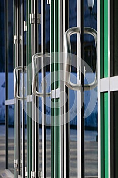 Chrome door handle and glass of modern aluminium office facade