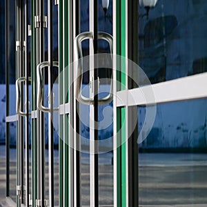 Chrome door handle and glass of modern aluminium office facade