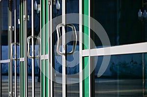 Chrome door handle and glass of modern aluminium office facade