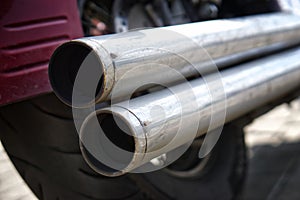 Chrome double motorcycle exhaust pipe. Problems of ecology and air pollution