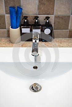 Chrome faucet washbasin. Interior of bathroom with sink basin faucet.