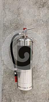 Chrome fire extinguisher hanging on pole