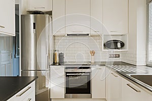 Chrome fridge in white kitchen