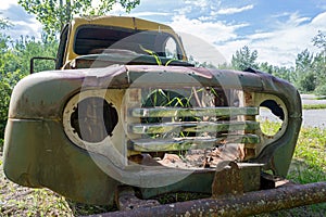 Chrome grille of an abandoned truck without an engine