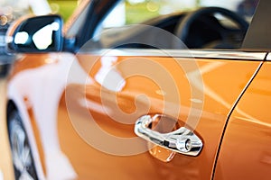 Chrome metallic handle of new orange car