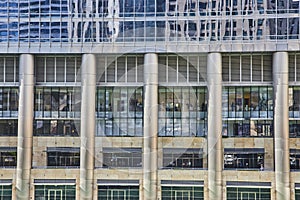 Chrome pillars with reflective windows and bars between in architecture view of Chicago, IL building