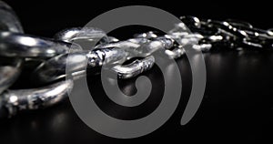 Chrome plated metal chain steel chain on black background