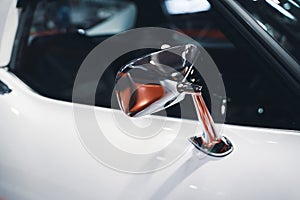 chrome rear mirror on white car with classic design