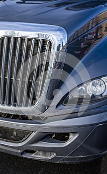 Chrome shiny grille and another parts of big rig gray semi truck