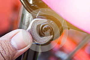 Chrome spanner with nut and bolt.