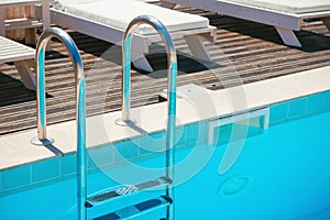 Chrome stairs with empty swimming pool