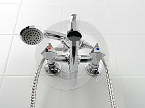 Chrome water tap in white bathroom