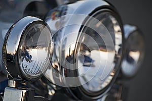 Chromed motorcycle headlights close up