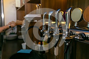 Chromed taps for draft beer in a modern bar