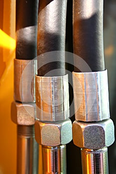 The chromeplated nuts and the reinforced hoses of hydraulic photo