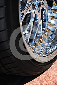 The chromeplated rim of a wheel