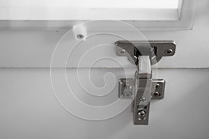 Chromic cabinet swing door hinge, build in furniture fittings hardware for wardrobe, cupboard or kitchen. Closeup of